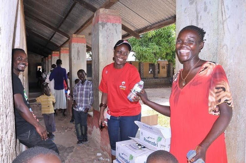 Airtel's Amanda sharing water with the residents that turned up for the Community health fair in Arua