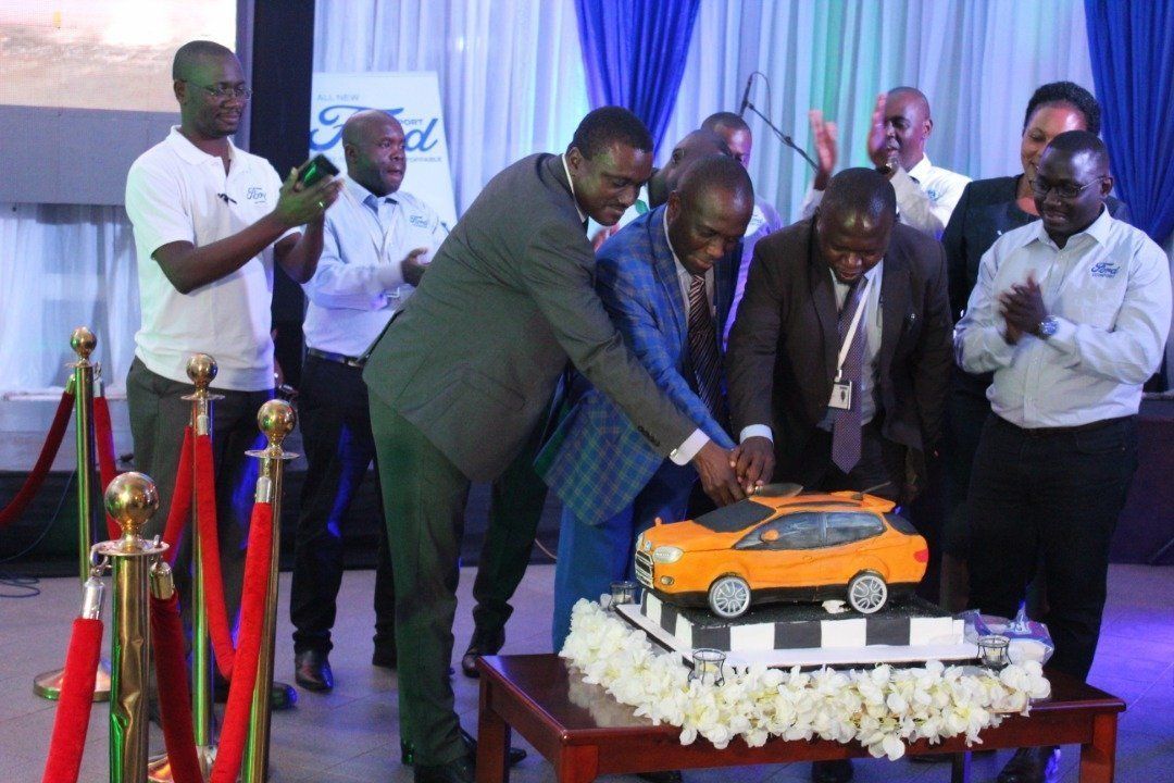 CMC Uganda officials utting a cake to launch the Ford EcoSport