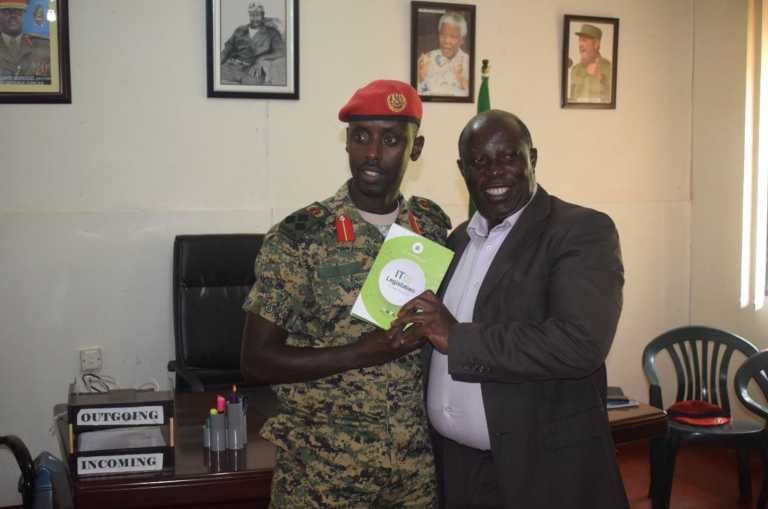 NITA’s James Saaka hands over copies of all the laws that governs the Uganda cyberspace to Brigadier Sabiiti.