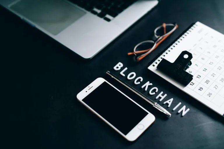smartphone pen calendar and eyeglasses on flat surface Blockchain